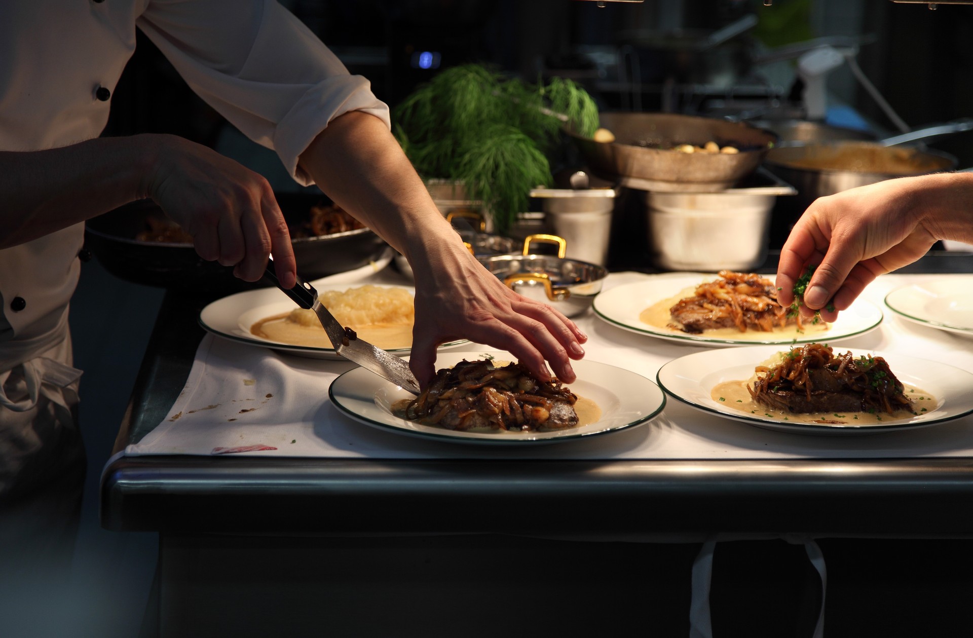 chef plating up in a restaurant kitchen